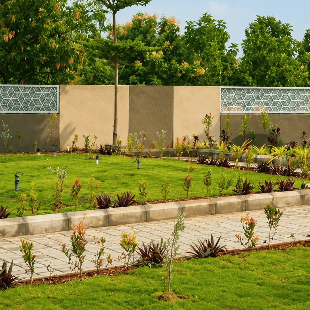 Landscaped gardens and paved walking paths running between the villa plots at Brickland Platinum